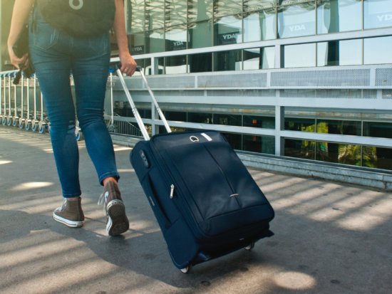 Female pulling suitcase at the airport