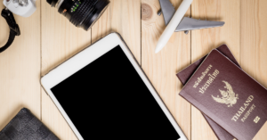 tablet, toy plane, camera and passport