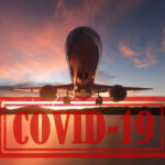 plane taking off at sunset with covid 19