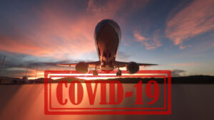 plane taking off at sunset with covid 19