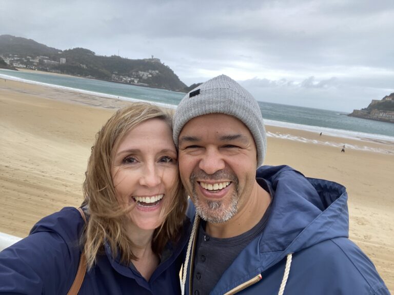 Trudy Traveler and husband on beach in Spain