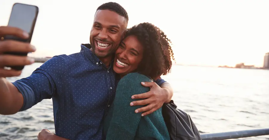 Summer bucket list ideas - couple smiling taking a selfie