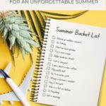 summer bucket list on a notepad, pineapple, and toy plane on a yellow surface