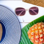 15 Cute Vacation Outfits For a Stylish Getaway: hat sunglasses, bag and pineapple